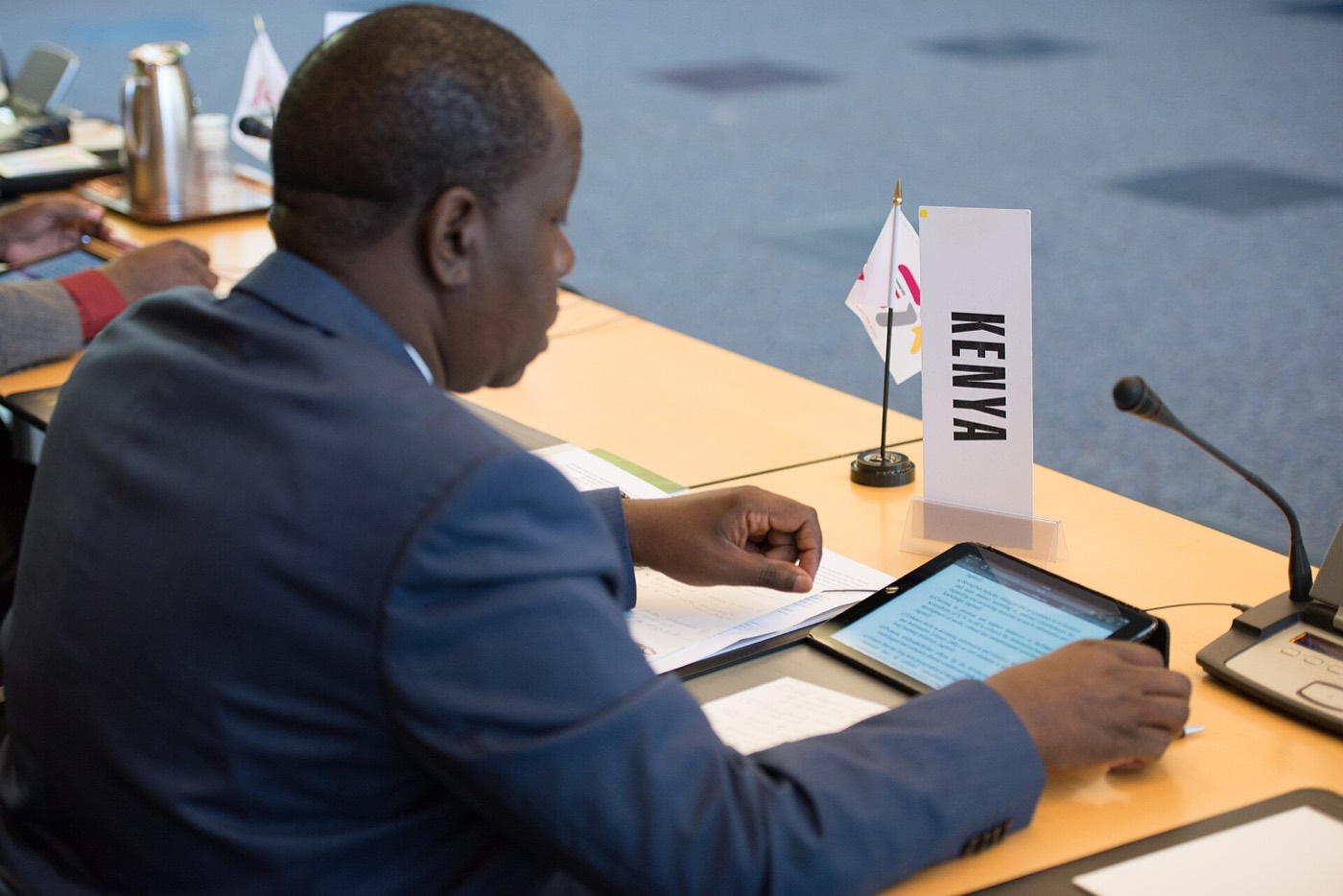 Fred Matiang'i seated at a conference table during a panel session