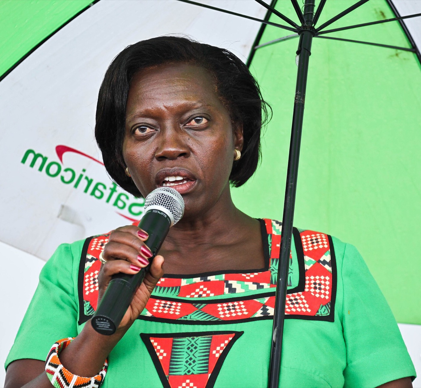 Martha Karua speaking into a microphone at a public forum