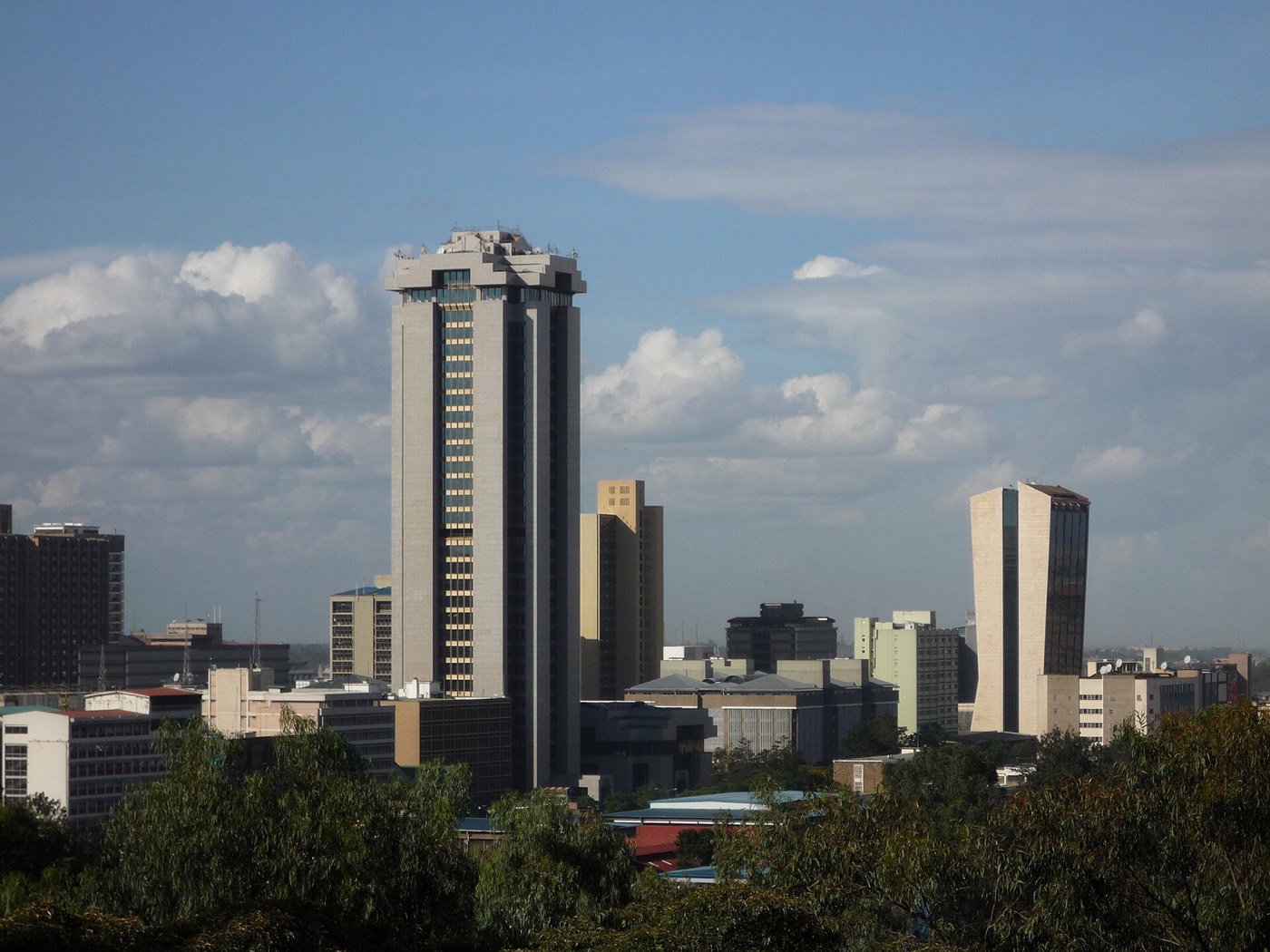 The Nairobi city skyline seen across low-rise rooftops